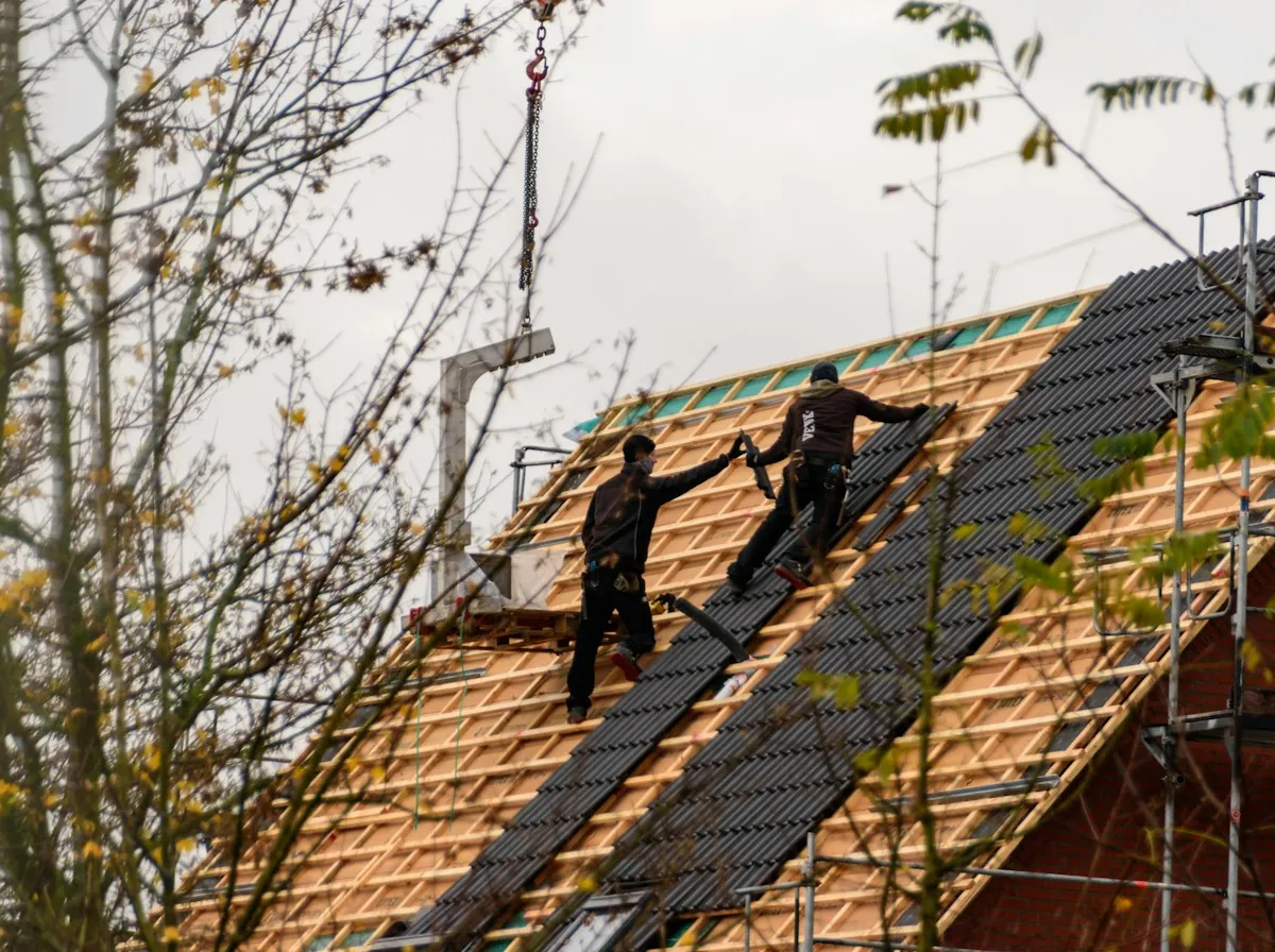 Roof Replacement in Glendale — roofers fixing new tiles to battens on a steep roof