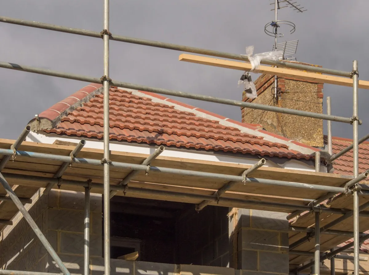 Roof Replacement in Glendale — a new tile roof going on behind scaffolding